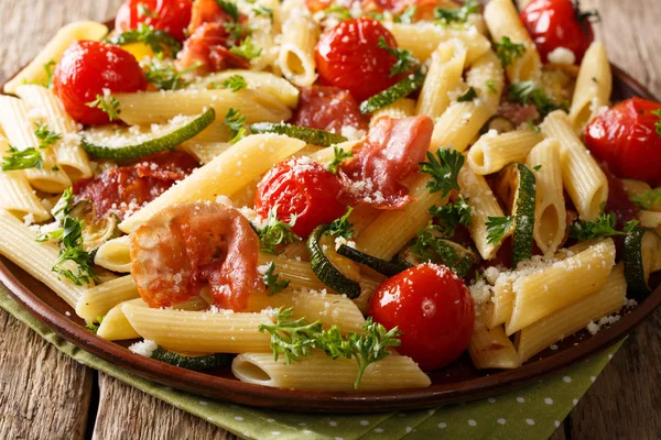 Leckere heiße Penne-Pasta mit Schinken, Kirschtomaten, Zucchini und — Stockfoto