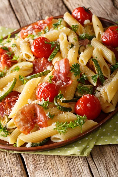 Italian penne pasta with fried prosciutto, tomato, zucchini and — Stock Photo, Image