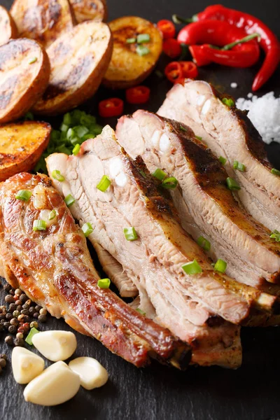 Kızarmış domuz eti ile fırında patates yakın çekim sıcak. Dikey ba