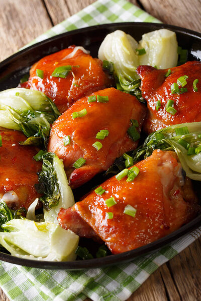 Spicy roasted chicken thighs with bok choy and green onions clos