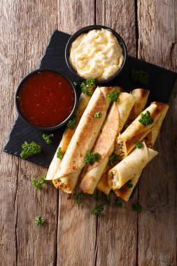 Mexican taquitos with chicken and cheese stuffing close-up, and  clipart