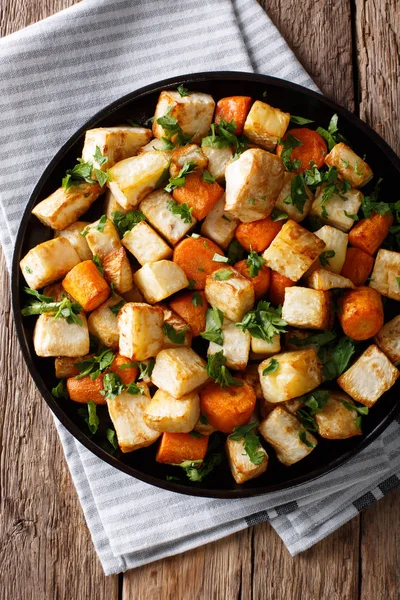 Roasted organic celery root and carrots close-up on a plate. Ver — Stock Photo, Image