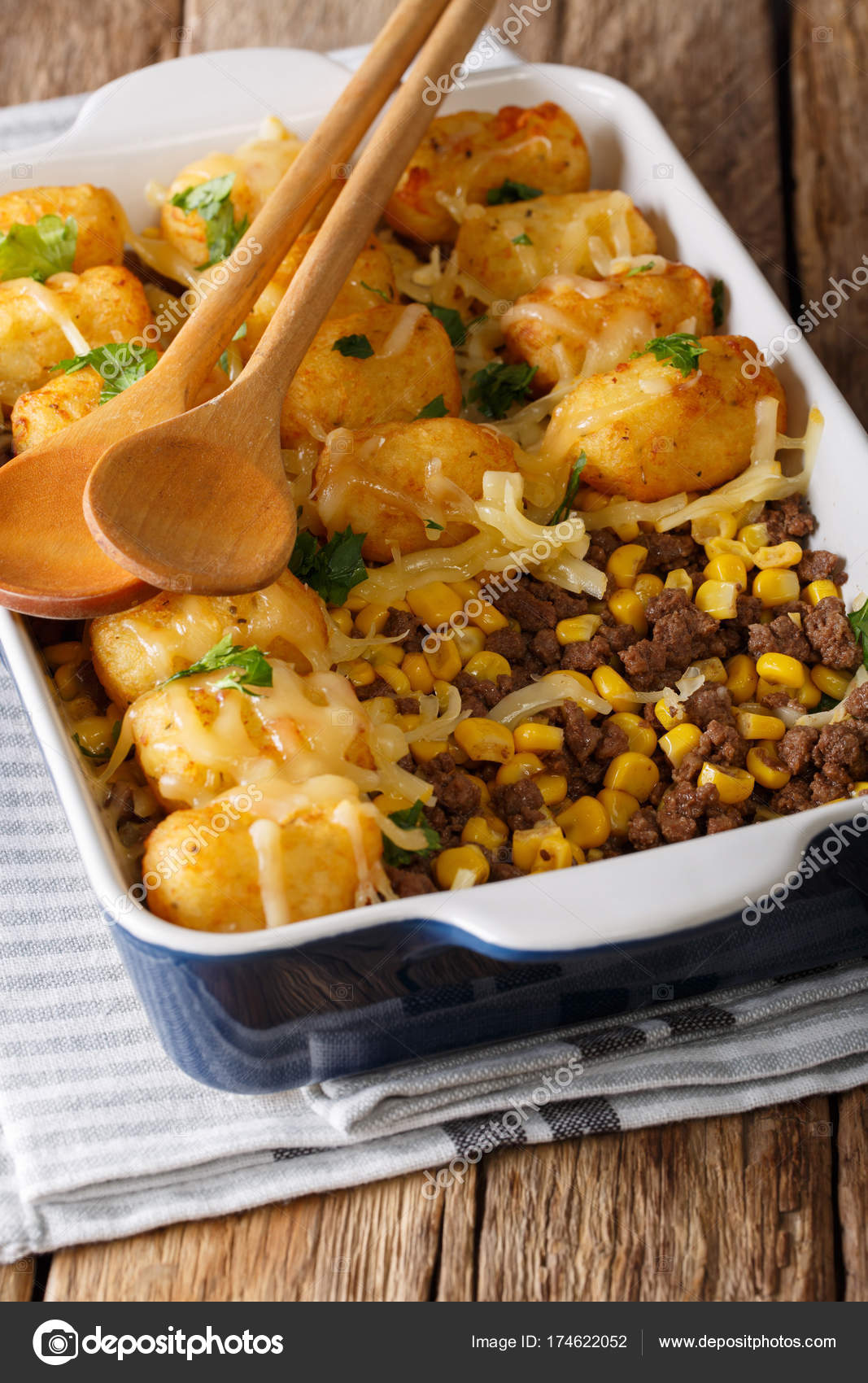 Baked Tater Tots with ground beef, corn and cheese closeup. ver Stock