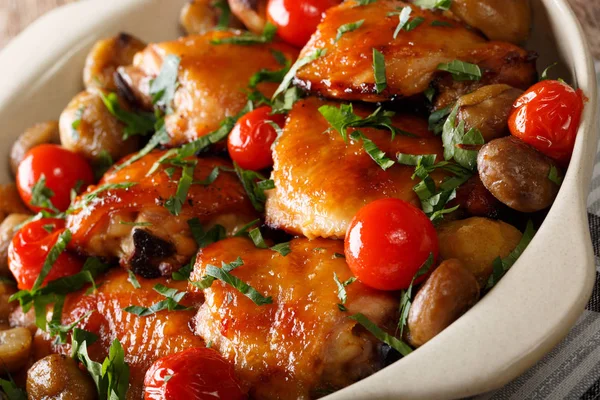 Chicken thighs baked with chestnuts and tomatoes close up. horiz — Stock Photo, Image