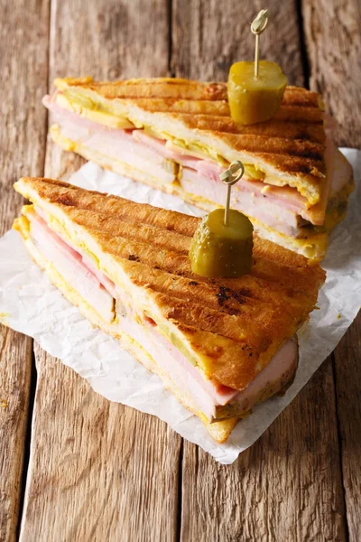 Delicious hot Cuban sandwich close-up on the table. vertical — Stock Photo, Image