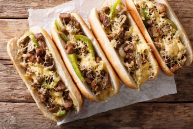 Philly cheese steak sandwich served on parchment paper close-up. clipart