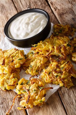 Hint çıtır çıtır kızarmış soğan Bhajis ve yoğurt yakın çekim. dikey