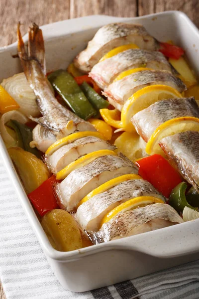 Dietary food pink cod baked with vegetables and lemon in a bakin