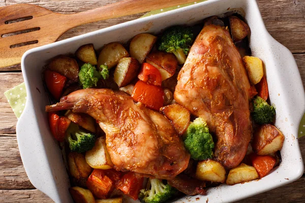 Rabbit baked with vegetables in mustard sauce close-up in baking — Stock Photo, Image