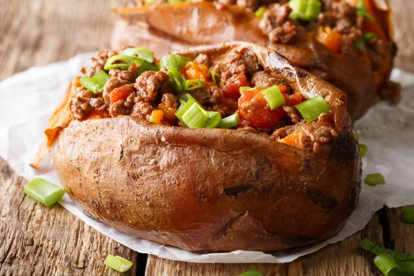 Baked sweet potatoes stuffed with ground beef with tomatoes and — Stock Photo, Image