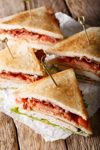 Club sandwich with turkey, bacon, cheese and vegetables close-up — Stock Photo, Image