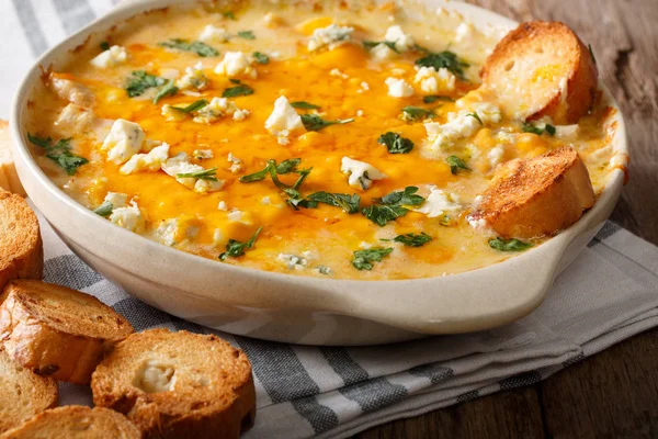 Homemade hot buffalo chicken dip with crostini close up in bakin