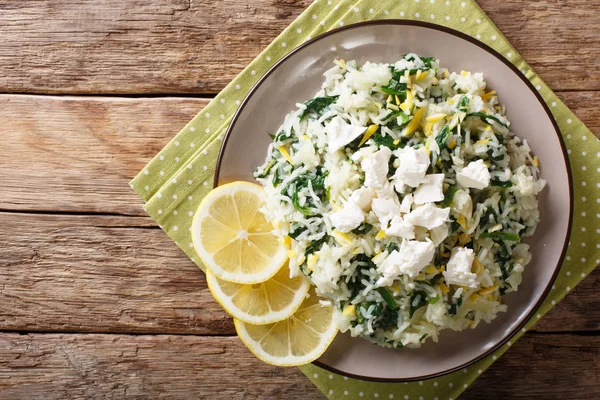 Spanakorizo rice with spinach, lemon rind and feta close-up. Hor — Stock Photo, Image