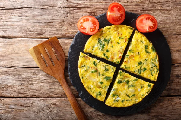 Egyptian food: omelet Igga with greens and onions close-up. Hori