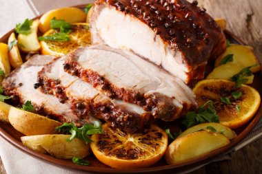 Kızarmış domuz eti bonfile ile patates, portakal ve elma yakın çekim