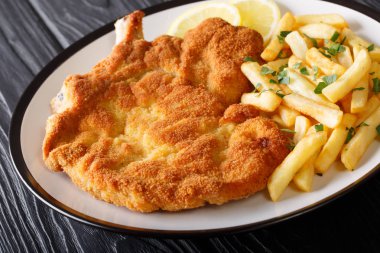 Veal alla Milanese (cotoletta alla milanese) with French fries c clipart