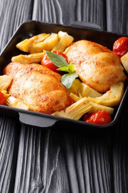 Kızarmış tavuk göğsü enginar ve domates cl ile servis edilir