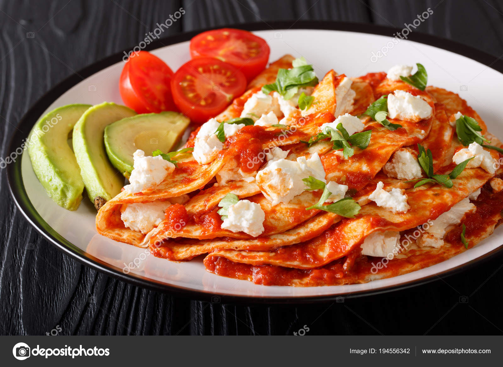 Mexican food entomatadas with farm cheese, tomato sauce, greens Stock Photo by ©lenyvavsha