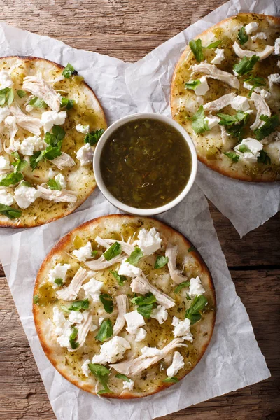 Mexican fast food: fried tortilla with chicken, cheese and green