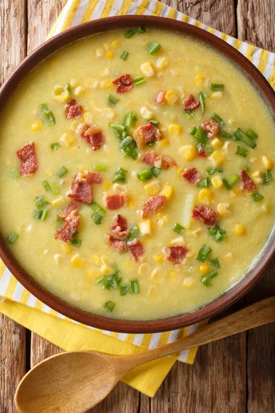 Winter soup corn chowder with bacon and green onions close-up in