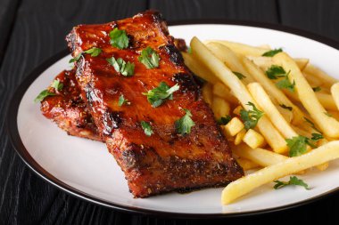 Patates kızartmalı, yapış yapış kaburgalar bir tabakta. ufuk