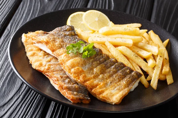 Menu of fried sea bass fillet with lemon and french fries close- — Stock Photo, Image