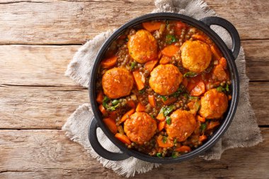 Spicy meatballs with lentil garnish in tomato sauce close-up in  clipart