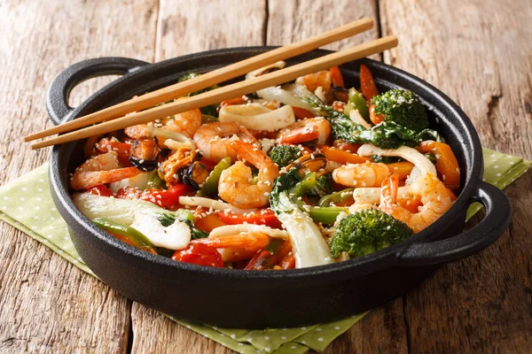 Tasty recipe for stir fry seafood with fresh vegetables close-up