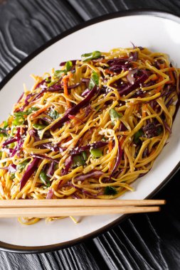 Vegetarian Asian egg noodle salad with seasonal vegetables close