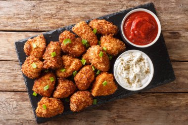 Delicious chicken nuggets breaded with coconut served with ketch