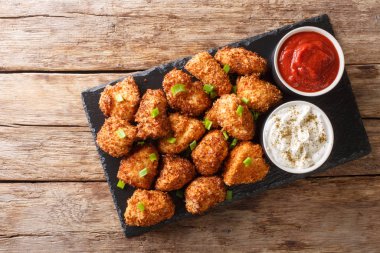 Portion Deep-fried chicken nuggets in coconut flakes served with