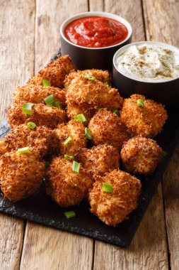 Crispy coconut chicken nuggets served with ketchup and mayonnais