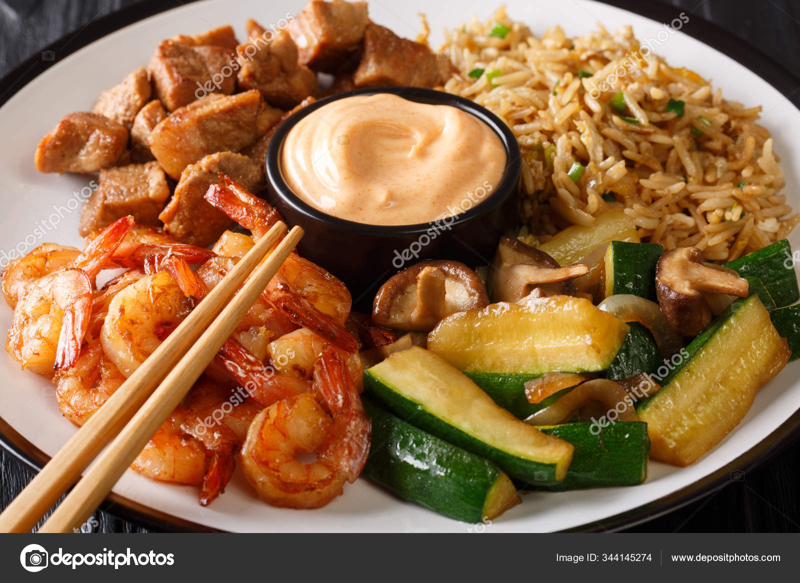 Hibachi dish consisting of fried rice with egg, shrimp, steak an