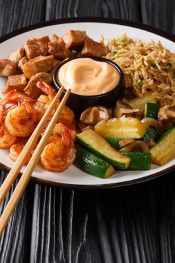 Hibachi fried rice with egg, shrimp, steak and vegetables close-
