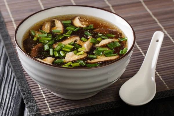 Zupa azjatycka z grzybami shiitake, zielone cebule zbliżenie w b — Zdjęcie stockowe