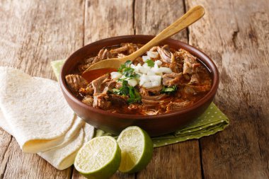 Tasty spicy Birria de Res from slowly stewed beef close-up in a bowl on the table. horizonta clipart