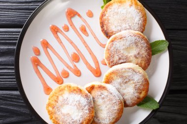 Masadaki tabakta pudra şekeri ve çilek reçeli ile Ukrayna mutfağı şurubu. Yukarıdan yatay üst görünüm