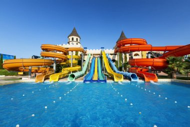 Aqua Paradise Nessebar, BULGARIA, September 10, 2017: View of the tower slides, blue swimming pool. clipart