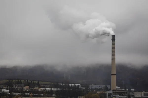 Atmospheric air pollution from Industrial cimney smoke in cloudy rainy day.