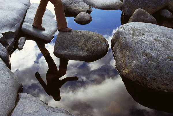 Reflection Of hiker Crossing  Stream — Stock Photo, Image