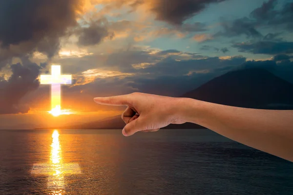 Pointing towards the Christian cross in the sky — Stock Photo, Image
