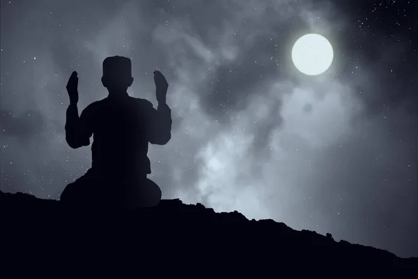 Silhouettes Muslim prayer,the light of faith, hope, faith, supplication,Concept of Islam is the religion, Young Muslim man praying mosque blurred background - Image