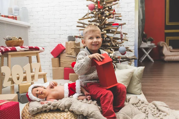 Souriant garçon et son petit frère près de l'arbre de Noël de mode — Photo