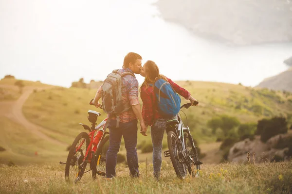 Young couple  riding bikes in the mountains — Stock Photo, Image