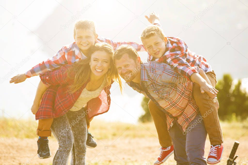 Family of four people riding bikes in the mountains