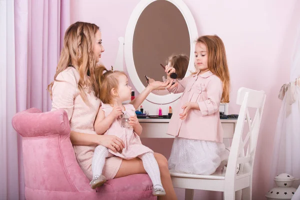 Mère et deux filles se maquillent les lèvres . — Photo