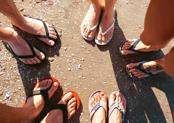 Five pare of legs on the sand of the beach — Stock Photo, Image