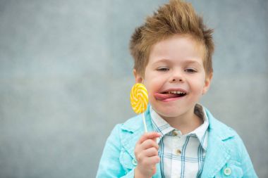 Lolipop gri duvarının yakınında olan moda çocuk