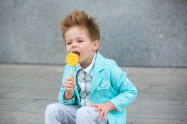 Lolipop gri duvarının yakınında olan moda çocuk