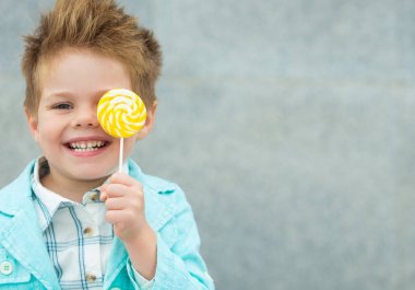 Lolipop gri duvarının yakınında olan moda çocuk